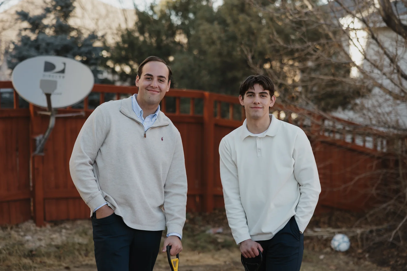 Ryan Isom on the left and Colton Isom on the right, together in a backyard